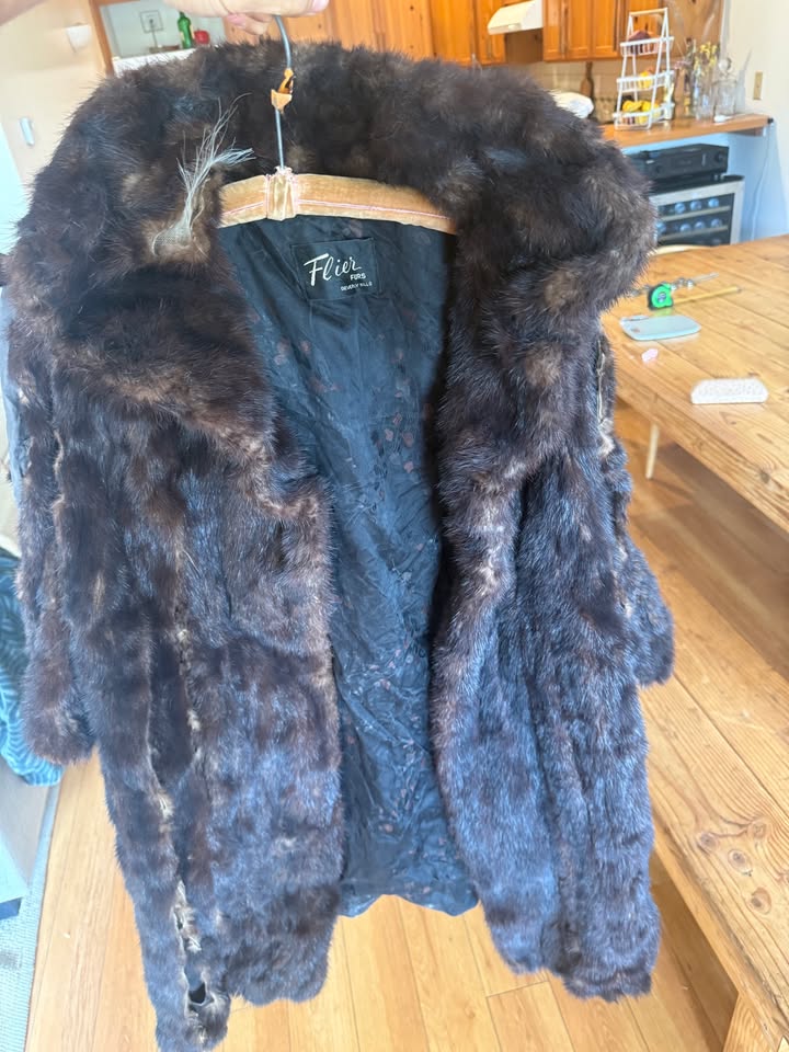 Mink coat on hanger showing wear